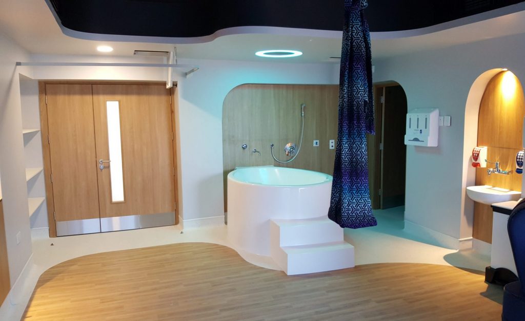 birthing room with birthing bath and birth sling